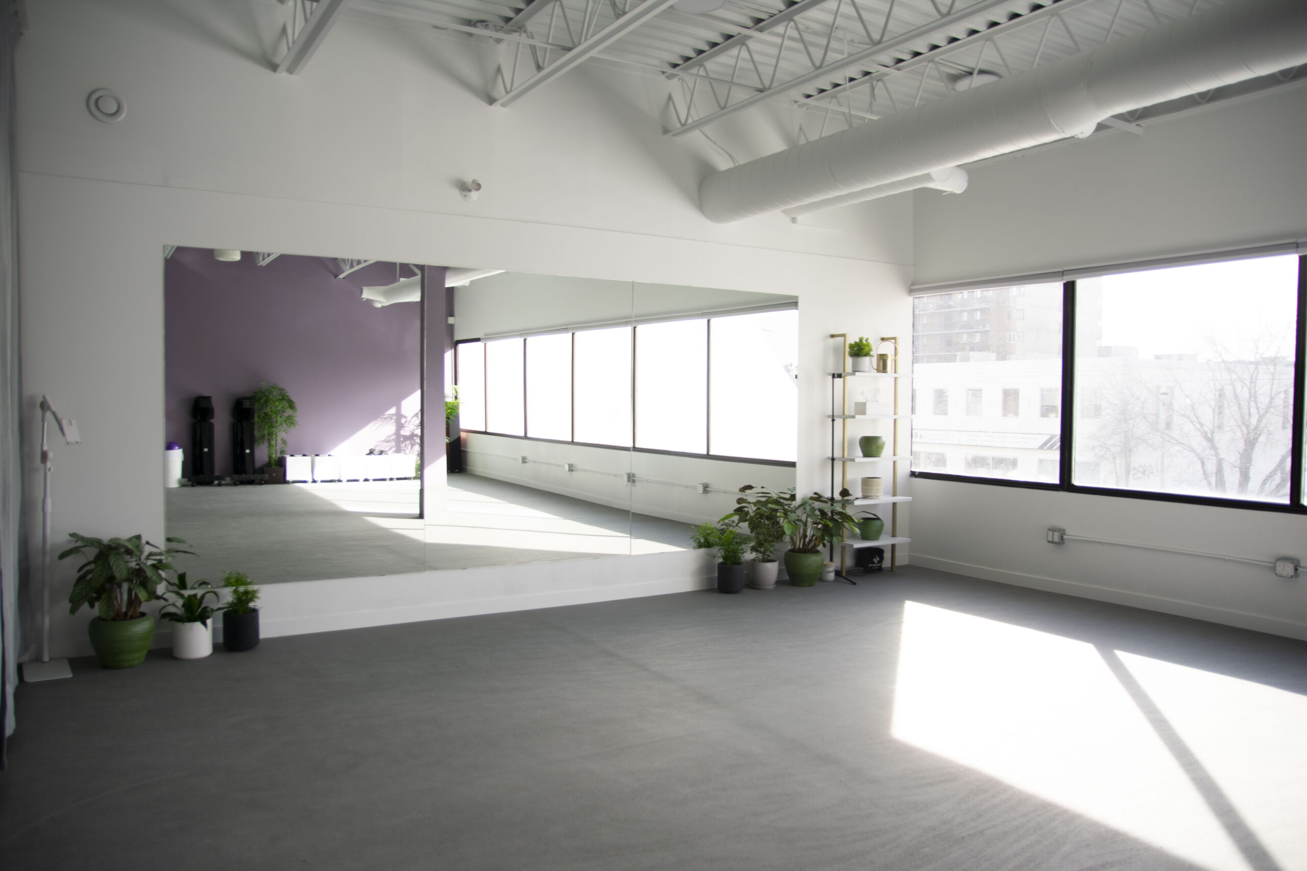 Unit 207 studio with mats, blocks, and natural light