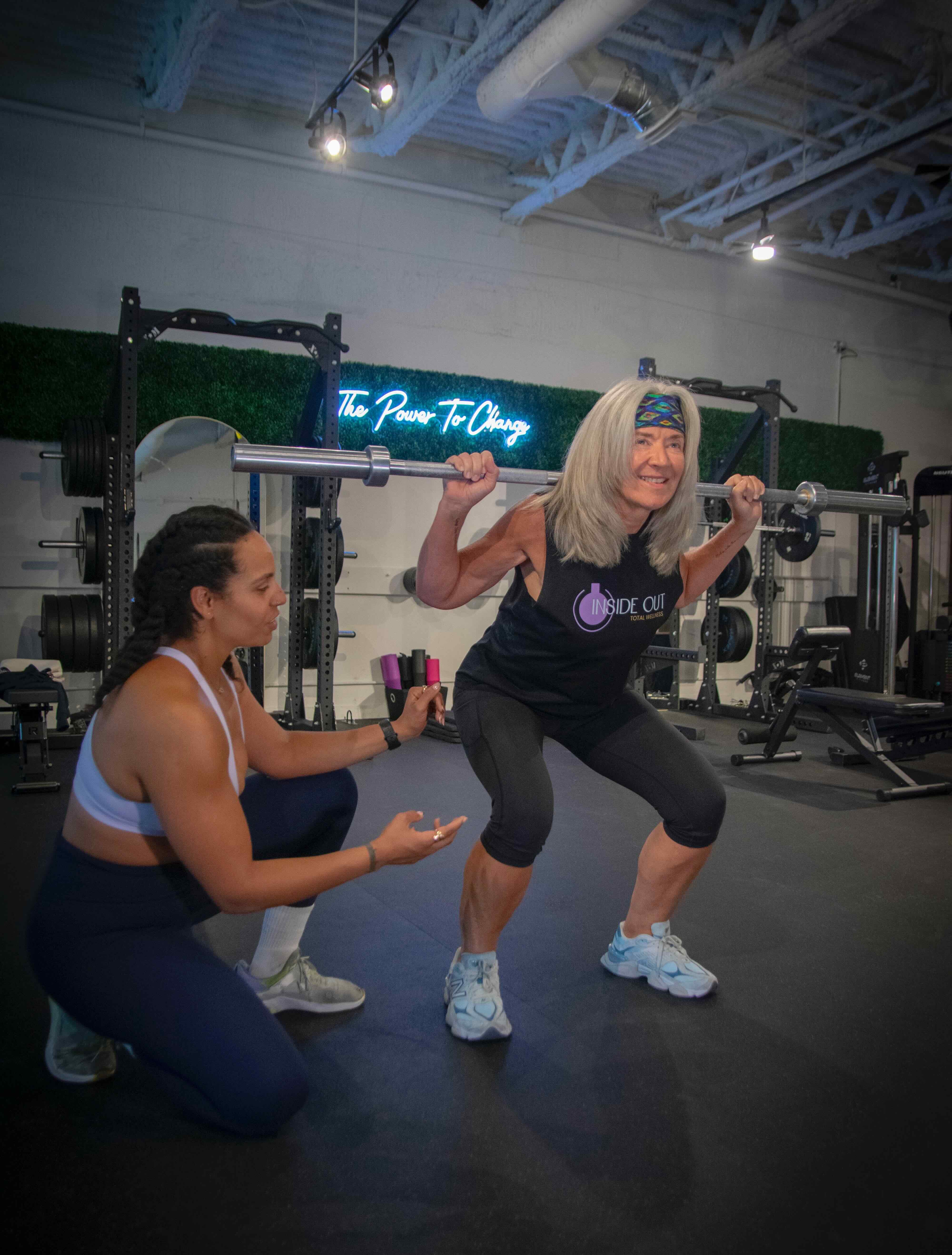 Coach guiding strength training in a private studio